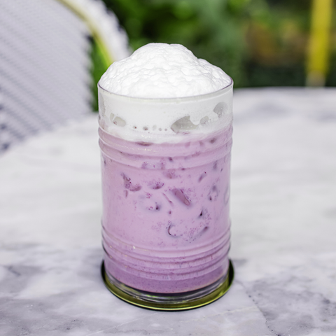 Free Recipe eBook with your order, shown with three ube drink ideas: an iced ube coffee with purple foam, a blended ube drink with cinnamon, and a hot ube latte held in a ceramic mug.